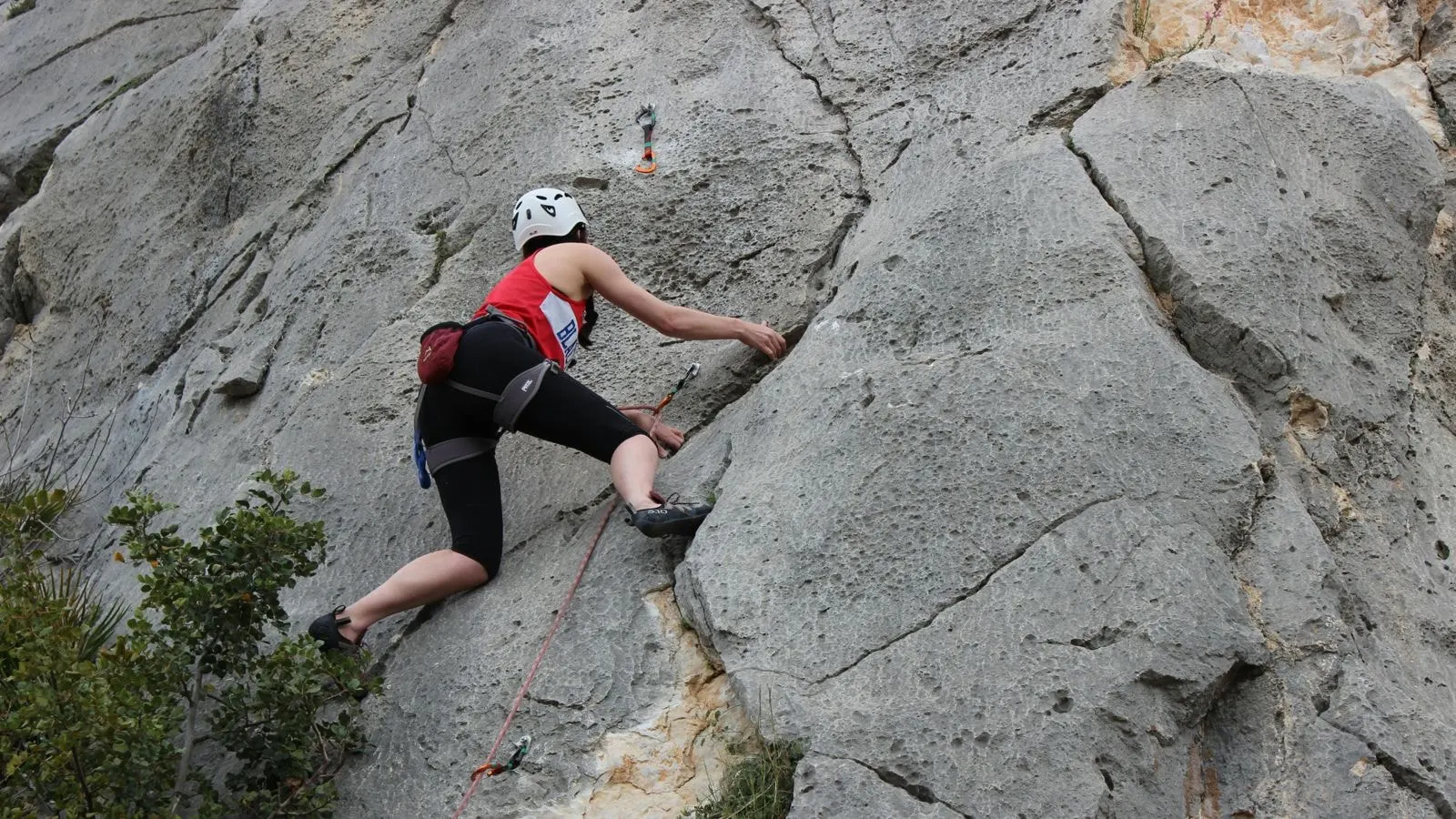 A climber on a limestone rock face